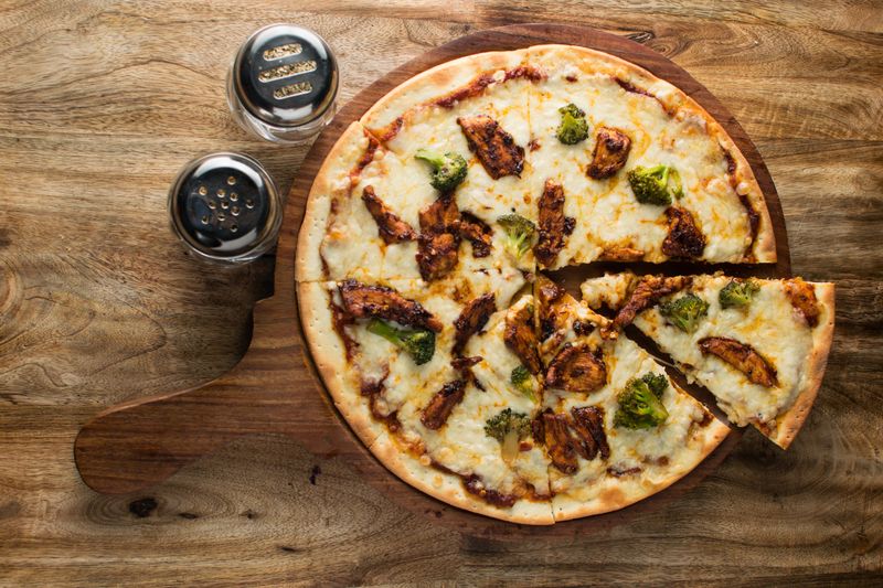 BBQ chicken pizza with caramelized onions and three-cheese blend